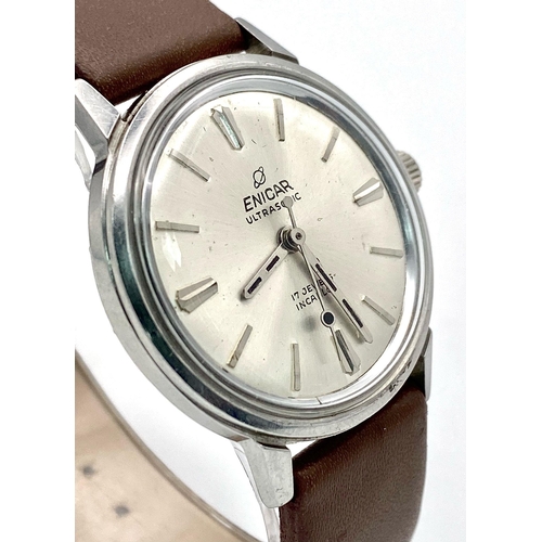 1002 - A Vintage Enicar Mechanical Gents Watch. Brown leather strap. Stainless steel case - 34mm. Silver to... 