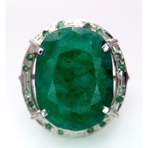 604 - An Oval Shape Brazilian Emerald 925 Silver Ring with Emeralds Accents. Weight - 17g total. 60ctw Eme... 