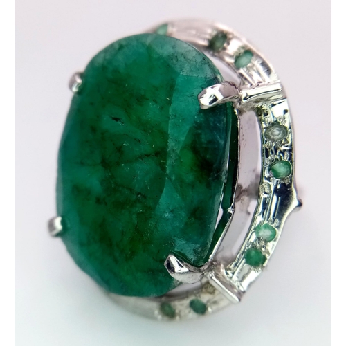 604 - An Oval Shape Brazilian Emerald 925 Silver Ring with Emeralds Accents. Weight - 17g total. 60ctw Eme... 