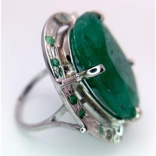 604 - An Oval Shape Brazilian Emerald 925 Silver Ring with Emeralds Accents. Weight - 17g total. 60ctw Eme... 