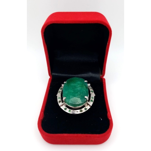 604 - An Oval Shape Brazilian Emerald 925 Silver Ring with Emeralds Accents. Weight - 17g total. 60ctw Eme... 