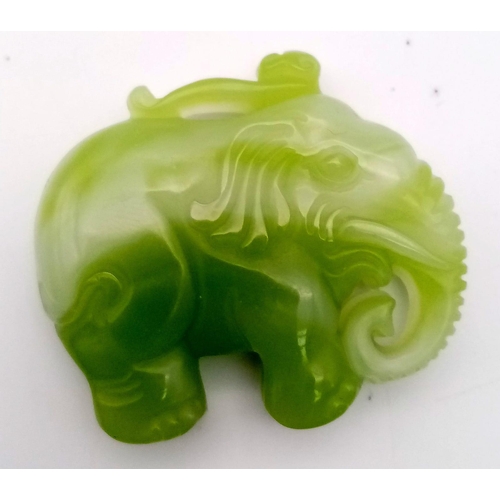 862 - A Chinese Green and White Jade Elephant Pendant. 5 x 4.5cm.