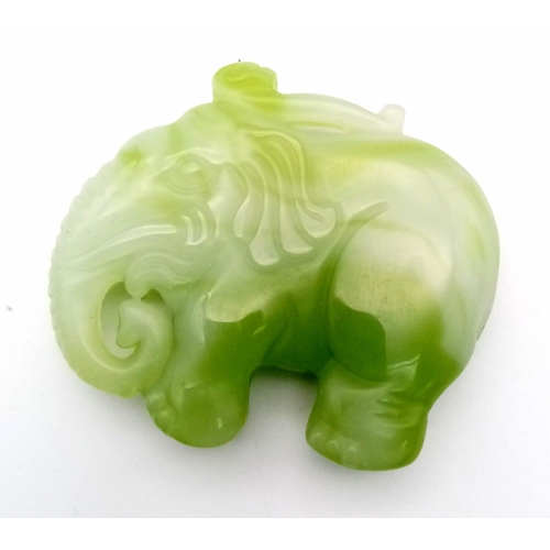 862 - A Chinese Green and White Jade Elephant Pendant. 5 x 4.5cm.