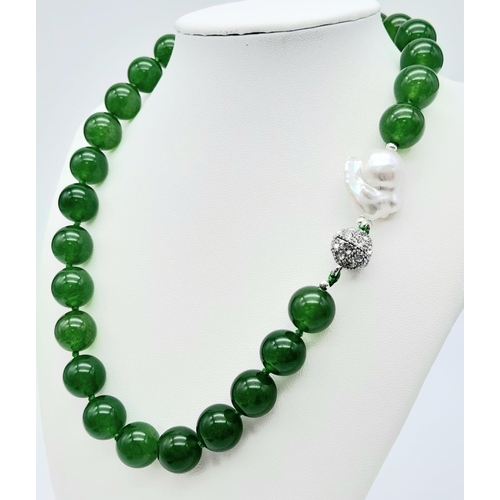 884 - A Green Jade and Keisha Baroque Pearl Necklace. 14mm green jade beads with a baroque pearl interrupt... 