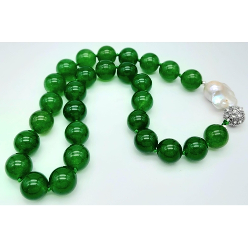 884 - A Green Jade and Keisha Baroque Pearl Necklace. 14mm green jade beads with a baroque pearl interrupt... 