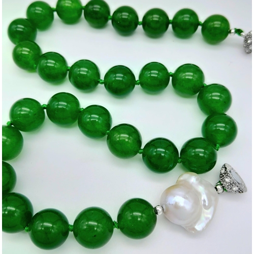 884 - A Green Jade and Keisha Baroque Pearl Necklace. 14mm green jade beads with a baroque pearl interrupt... 