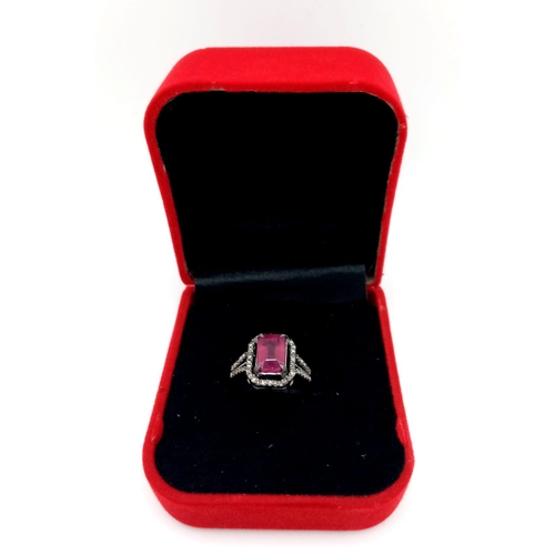 920 - A Rectangular Shaped Ruby and Diamond Ring set in 925 gun-metal silver. Central ruby with diamond su... 