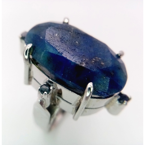 960 - A Blue Sapphire 925 Silver Ring with Sapphire Accents.  Weight - 19.60g. 65 carat large Madagascar C... 