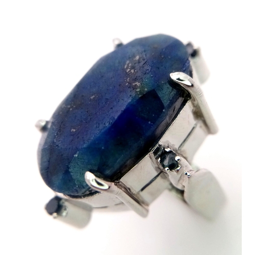 960 - A Blue Sapphire 925 Silver Ring with Sapphire Accents.  Weight - 19.60g. 65 carat large Madagascar C... 