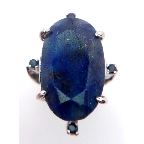 960 - A Blue Sapphire 925 Silver Ring with Sapphire Accents.  Weight - 19.60g. 65 carat large Madagascar C... 