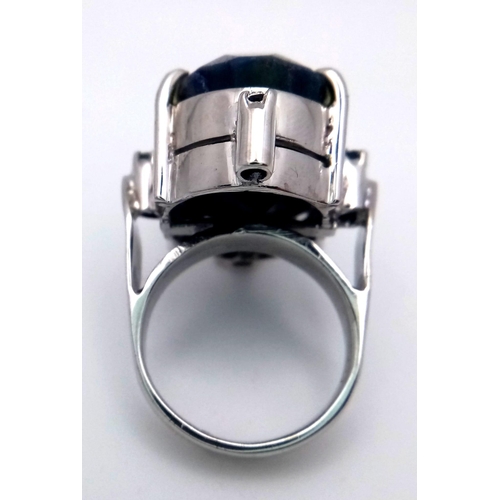 960 - A Blue Sapphire 925 Silver Ring with Sapphire Accents.  Weight - 19.60g. 65 carat large Madagascar C... 