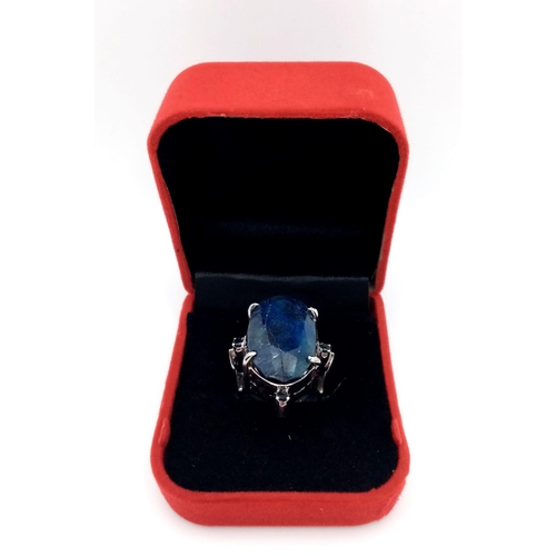 960 - A Blue Sapphire 925 Silver Ring with Sapphire Accents.  Weight - 19.60g. 65 carat large Madagascar C... 