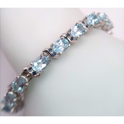 122 - An Ice Blue Topaz Gemstone Tennis Bracelet set in 925 Silver. Weight - 25.30g. 18cm length. Ref: HV-... 