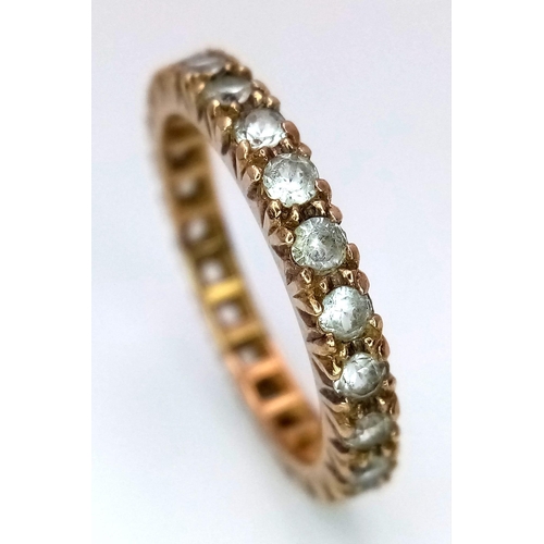 885 - A Vintage 9K Yellow Gold White Stone Eternity Ring. Size O. 2.75g total weight.