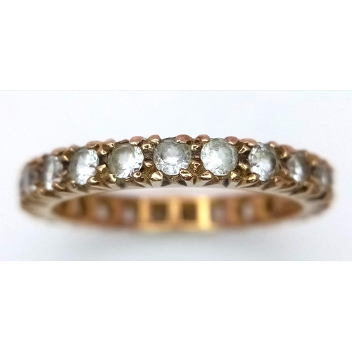 885 - A Vintage 9K Yellow Gold White Stone Eternity Ring. Size O. 2.75g total weight.