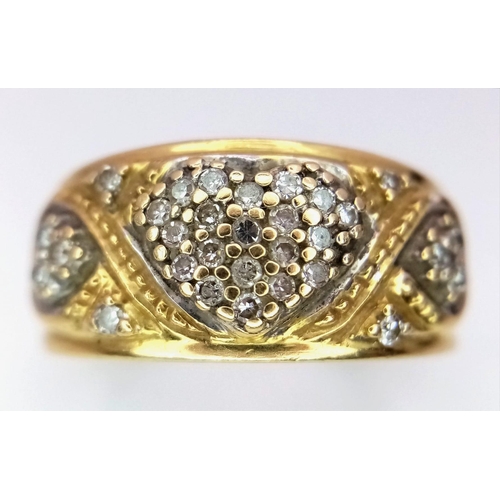 1144 - A Vintage 18K Yellow Gold Diamond Decorative Heart Ring. A central pave diamond heart with scrolls a... 