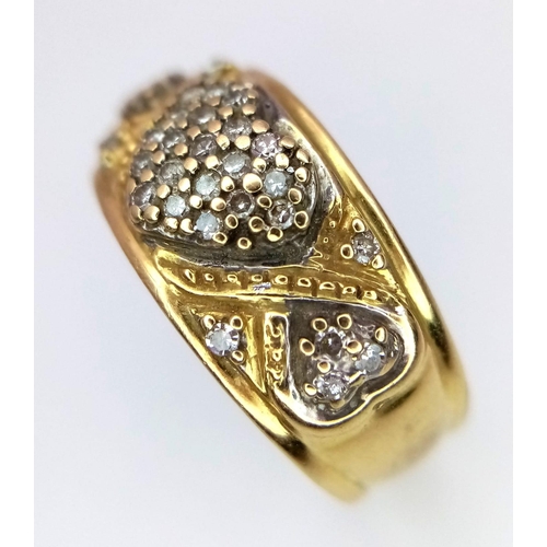 1144 - A Vintage 18K Yellow Gold Diamond Decorative Heart Ring. A central pave diamond heart with scrolls a... 