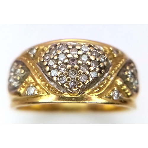 1144 - A Vintage 18K Yellow Gold Diamond Decorative Heart Ring. A central pave diamond heart with scrolls a... 