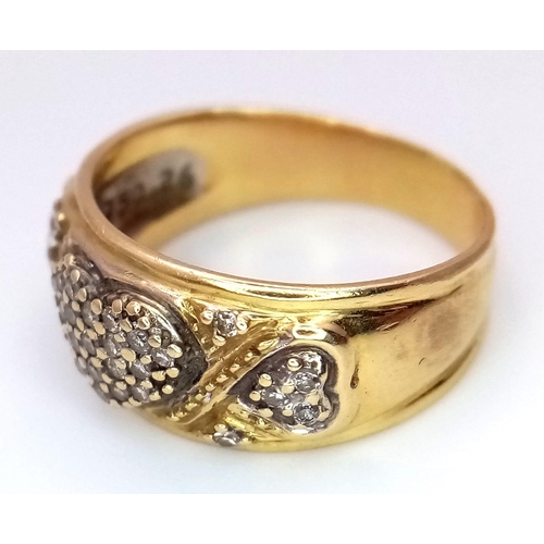 1144 - A Vintage 18K Yellow Gold Diamond Decorative Heart Ring. A central pave diamond heart with scrolls a... 