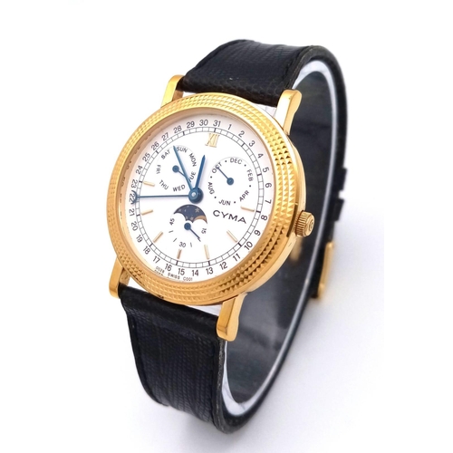 1324 - A Cyma Quartz Moonphase Watch. Black leather strap. Gilded case - 32mm. White dial with three sub di... 