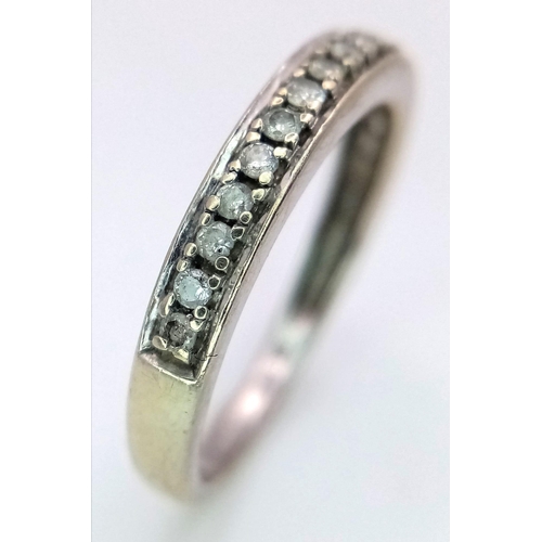 1366 - A 9K Gold and Diamond Half Eternity Ring. 0.20ctw. Size N. 2g total weight.