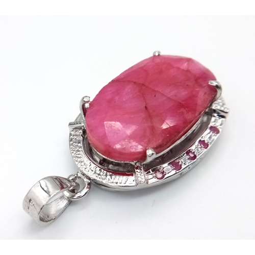 787 - An Oval Shape Ruby Gemstone Pendant set in 925 Silver with Ruby Accents. 24.20g total weight. 95ctw ... 