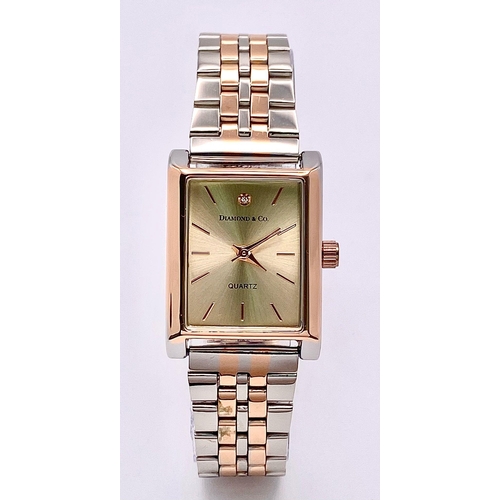 978 - An Unworn Diamond & Co. Ladies Bi-Metal Tank Style Watch. The Watch is set with a Certified 1mm Roun... 