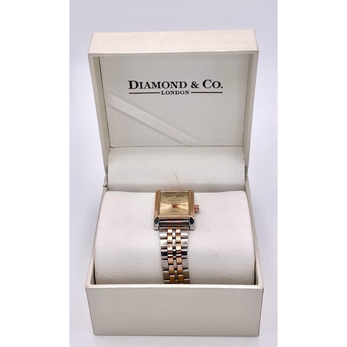 978 - An Unworn Diamond & Co. Ladies Bi-Metal Tank Style Watch. The Watch is set with a Certified 1mm Roun... 