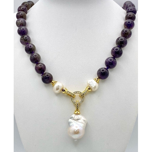 254 - A Gorgeous Amethyst Bead Necklace with a Hanging Keisha Baroque Pearl Pendant. Gilded clasp with whi... 