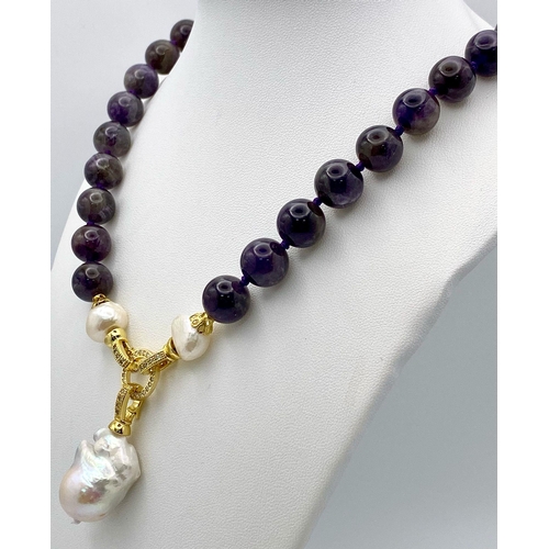 254 - A Gorgeous Amethyst Bead Necklace with a Hanging Keisha Baroque Pearl Pendant. Gilded clasp with whi... 