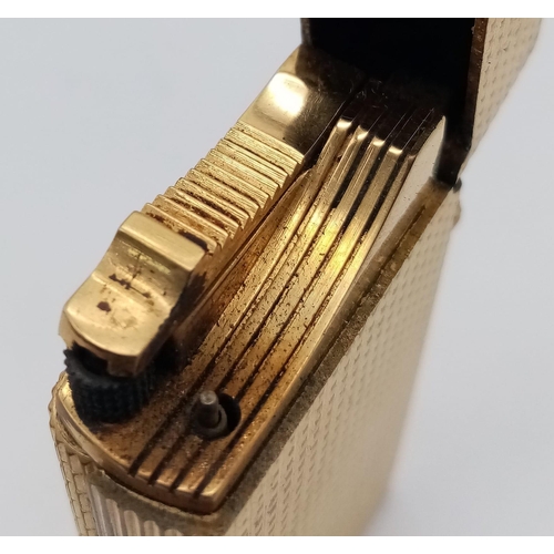 626 - A Vintage Dunhill Gold Plated 70 Lighter. Textured exterior - 6cm x 3cm. In need of flint and gas. C... 