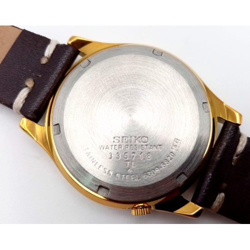 919 - A Seiko Automatic Mickey Mouse Watch. Brown leather strap. Gilded stainless steel case - 36mm. Decor... 