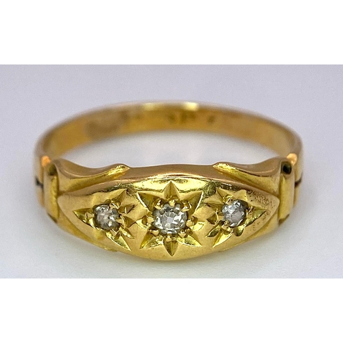 696 - An Antique 18K Yellow Gold Three Stone Diamond Ring. Three bright white diamonds in star settings. S... 