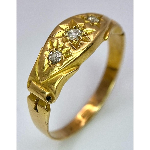 696 - An Antique 18K Yellow Gold Three Stone Diamond Ring. Three bright white diamonds in star settings. S... 