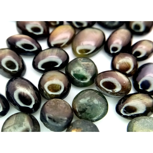 1351 - A Parcel of 68 Black Star Diopside Oval Cabochons. 49.86 Carats Total.