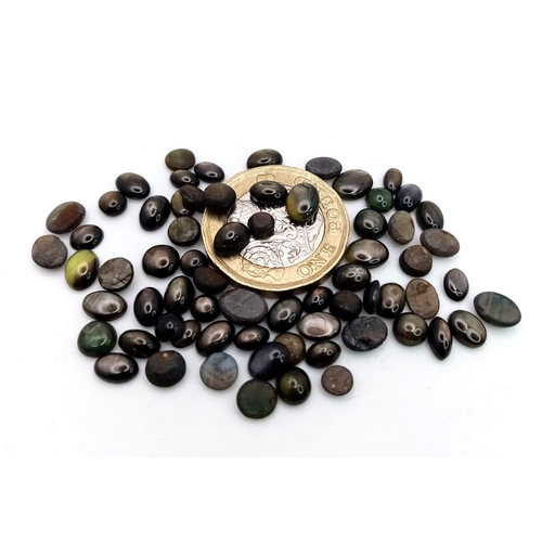 1351 - A Parcel of 68 Black Star Diopside Oval Cabochons. 49.86 Carats Total.