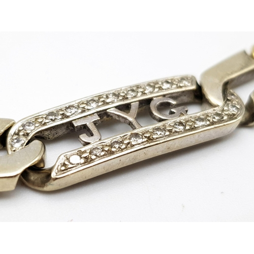 106 - An 18K Yellow and White gold Diamond Bracelet. A double row of flat yellow gold curb links connect t... 