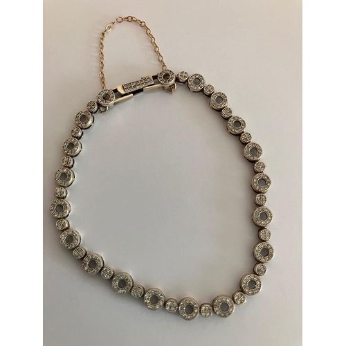 188 - SILVER and DIAMOND TENNIS BRACELET complete with safety chain. 19 cm.