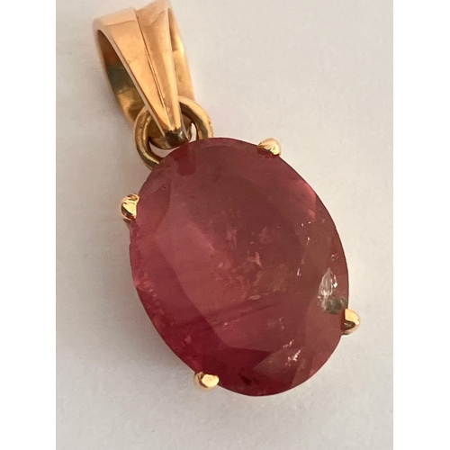 215 - 14 carat GOLD and PINK TOURMALINE PENDANT. Consisting an oval cut Tourmaline set in a Deep cradle mo... 