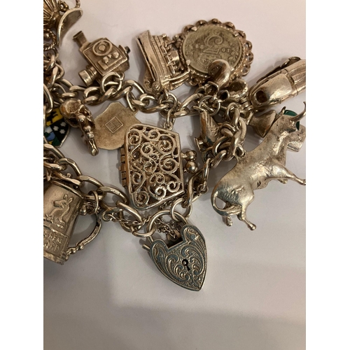 278 - Vintage SILVER CHARM BRACELET Full of unusual SILVER CHARMS. To include Jaguar E-type, Vintage polic... 