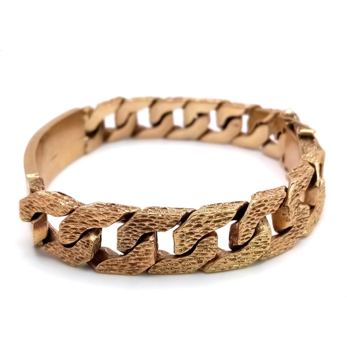 471 - A CHUNKY 9K GOLD I.D. BRACELET WITH BARK EFFECT LINKS AND SAFETY CHAIN .   59.2gms