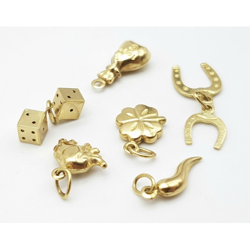 1203 - A BAG OF 6 9K GOLD CHARMS TO INCLUDE AN ELEPHANT , DICE , 4 LEAF CLOVER AND MORE .   3.4gms