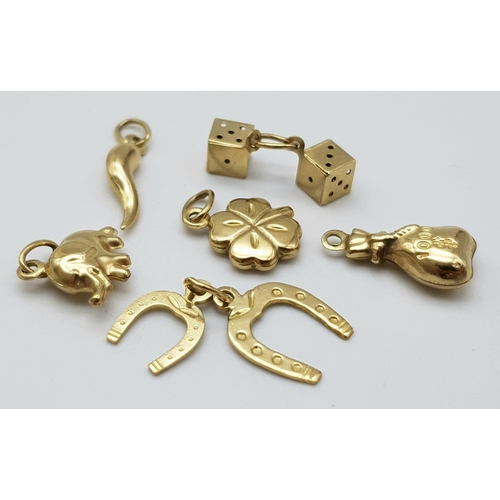 1203 - A BAG OF 6 9K GOLD CHARMS TO INCLUDE AN ELEPHANT , DICE , 4 LEAF CLOVER AND MORE .   3.4gms