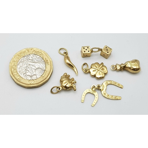 1203 - A BAG OF 6 9K GOLD CHARMS TO INCLUDE AN ELEPHANT , DICE , 4 LEAF CLOVER AND MORE .   3.4gms