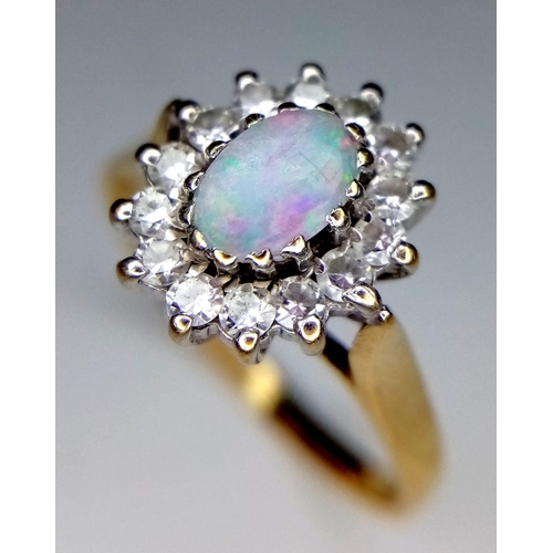 297 - 9K YELLOW GOLD OPAL AND CZ RING - 5MMX6MM OPAL CENTRE WITH HALO OF CZ STONE SETTING - 2.4G TOTAL WEI... 