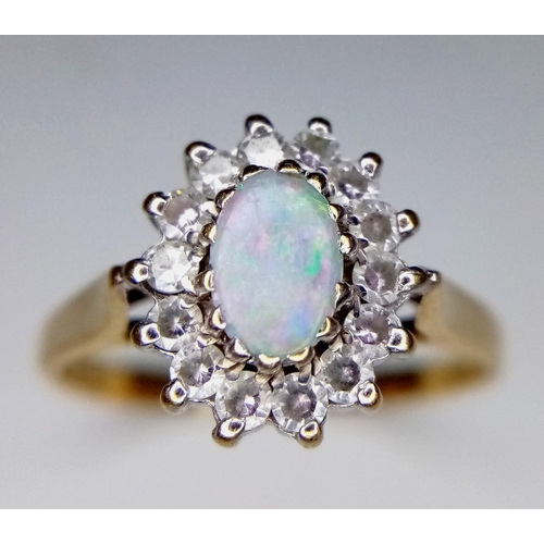 297 - 9K YELLOW GOLD OPAL AND CZ RING - 5MMX6MM OPAL CENTRE WITH HALO OF CZ STONE SETTING - 2.4G TOTAL WEI... 