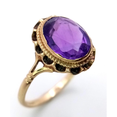 304 - A VINTAGE 9K YELLOW GOLD AMETHYST RING - 2.4CT FACETED OVAL AMETHYST SOLITAIRE STONE- 2.3G TOTAL WEI... 