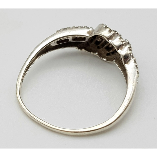 141 - A 9K WHITE GOLD AND DIAMOND RING .   2.5gms   size O