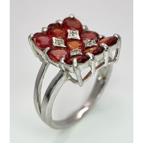 158 - A 9K WHITE GOLD ORANGE STONE SET FANCY RING 4.3G SIZE N.

SC 4005