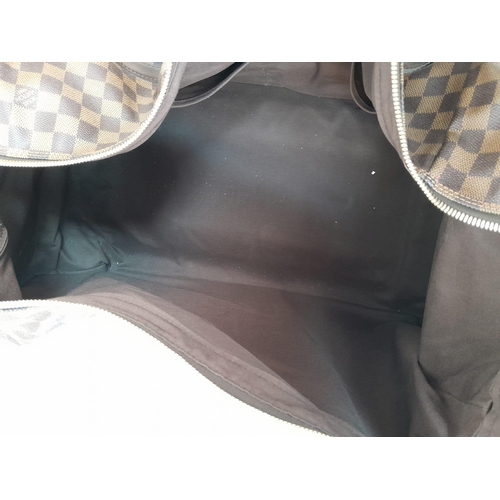 17 - A Louis Vuitton Damier Ebene Eole Convertible Travel Bag. Leather exterior with gold-toned hardware,... 